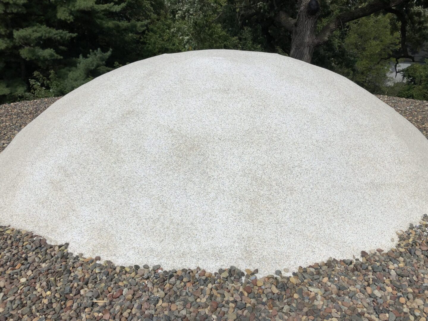 white dome construction for insulation surrounded by pebbles