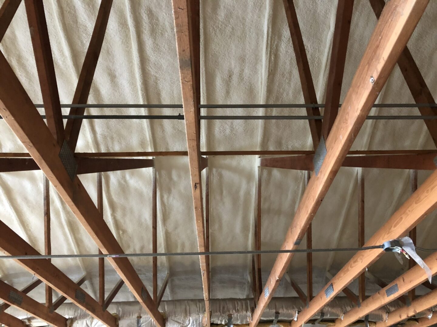 wooden beams on ceiling of construction with insulation