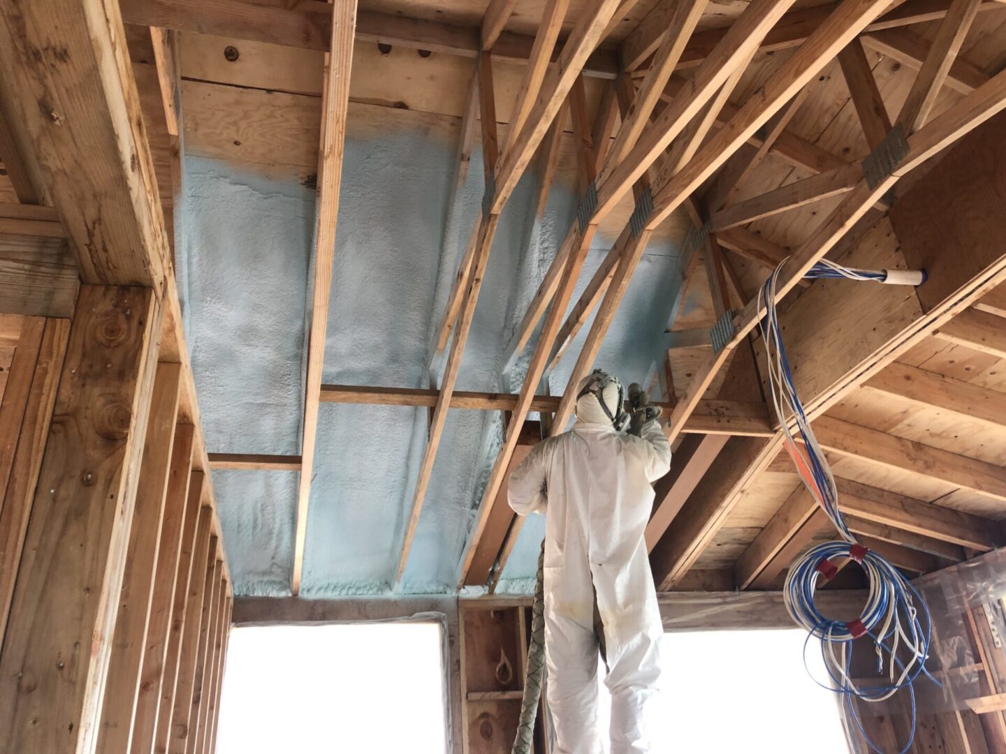 spraying insulation on ceiling