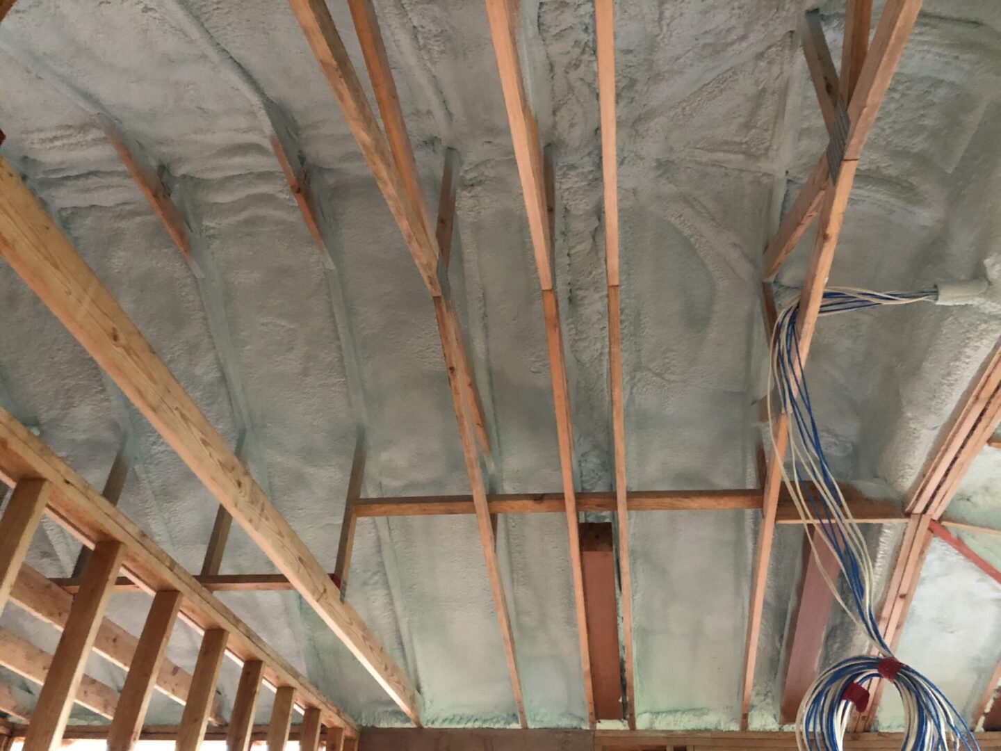 Beams and ceiling with spray on insulation
